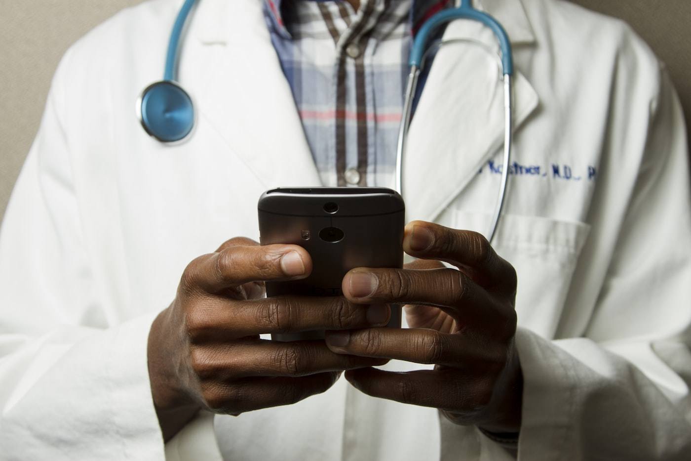 Doctor reviewing a case on a phone